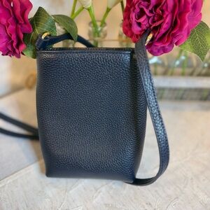 Navy pebble leather crossbody phone / tech bag snap closure and gold hardware.
